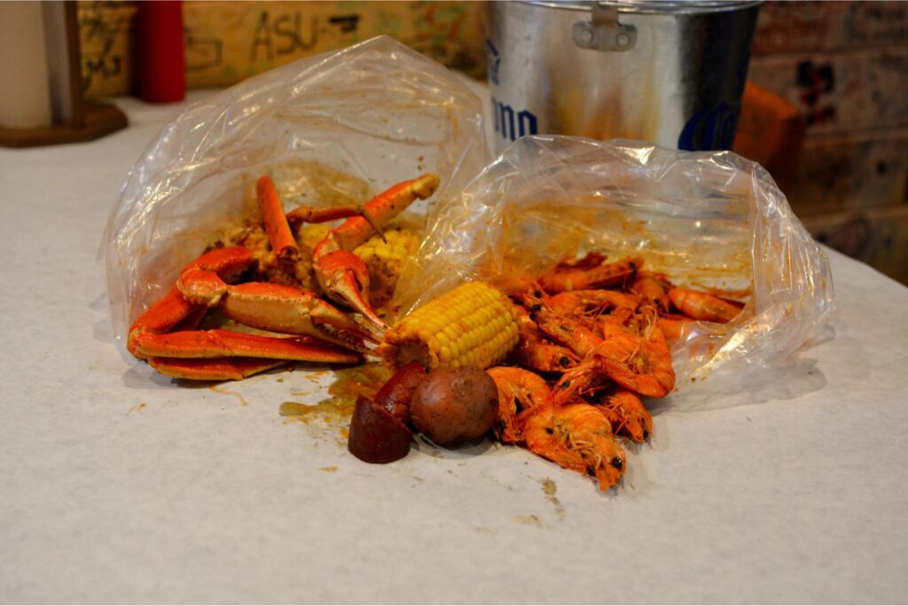 Seafood boil spilling out of a bag.