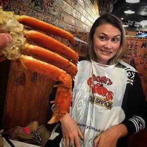woman posing with crab legs